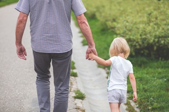 father walking hand in hand with daughter