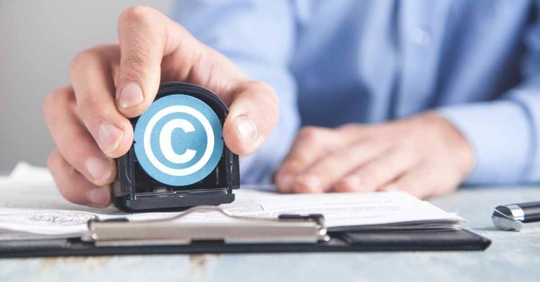 A person stamping something with a "Copyright" symbol