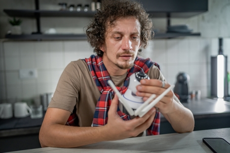 man examining defective electronic