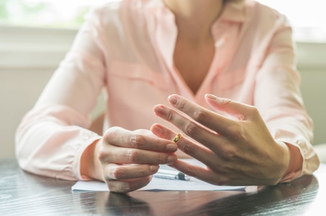 woman taking wedding ring off