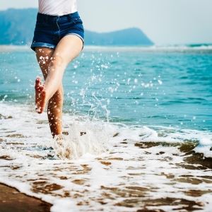 woman kicking ocean water