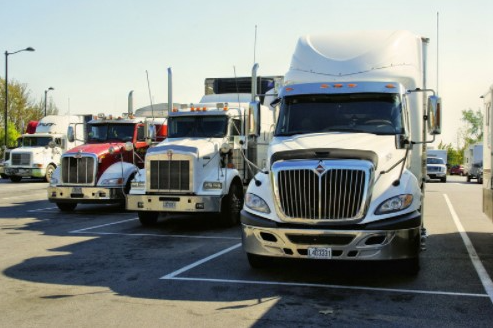 commercial trucks parked in a parking lot