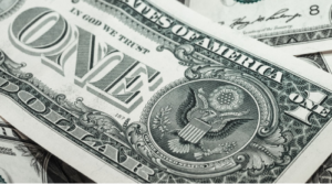 A close-up of U.S. dollar bills, symbolizing finances and retirement assets.